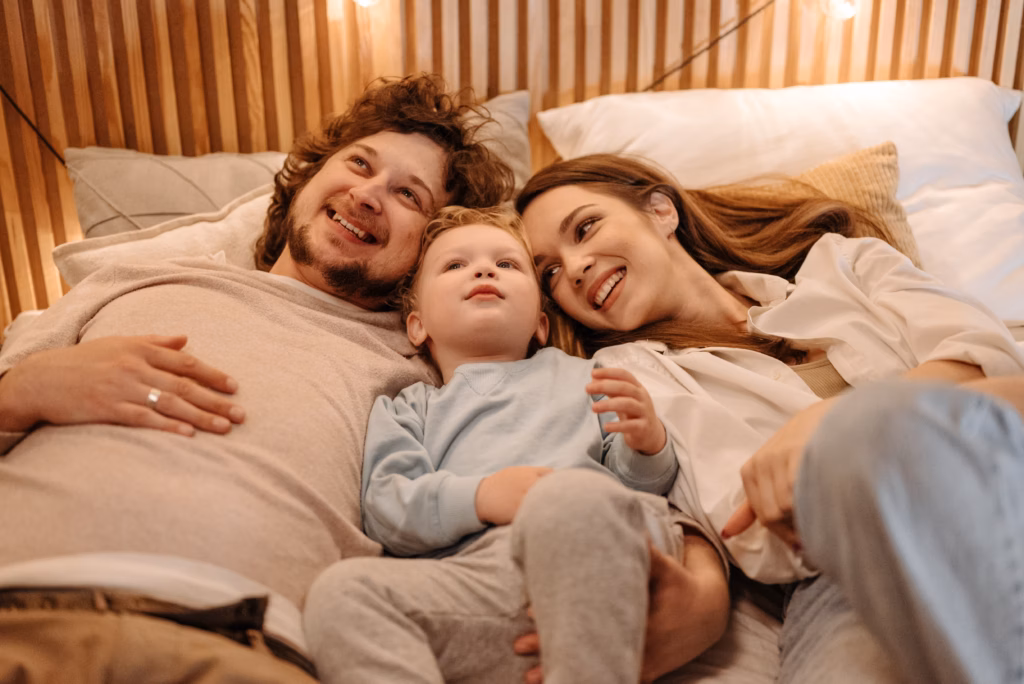 family laying together in bed